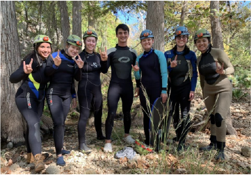 Erica McCormick ecohydrologist standing with Marcus Gary's Karst 2019 class in front of Honey Creek Cave